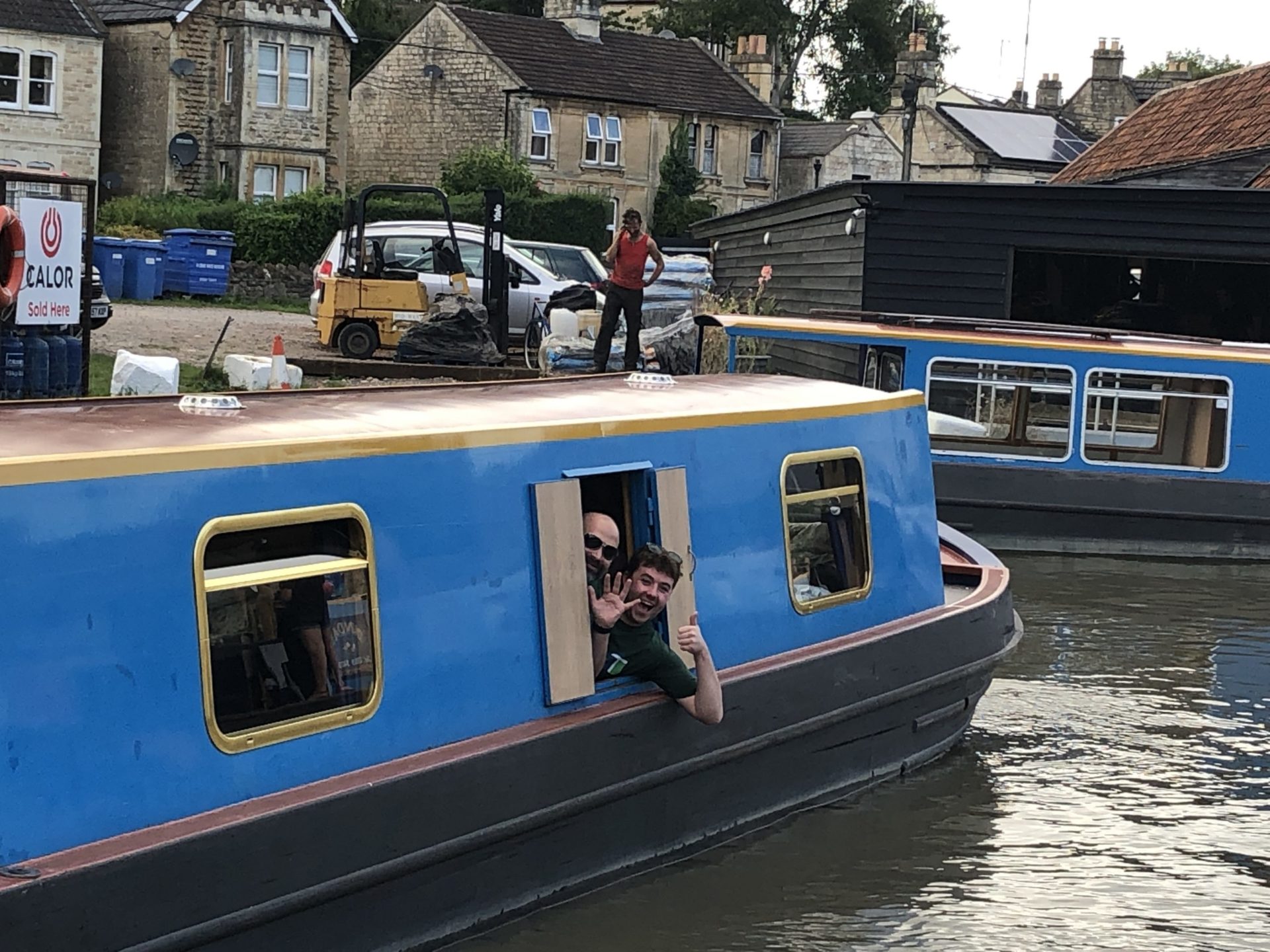 waving out of window of narrowboat